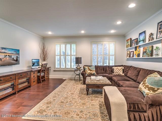 19 Russell Road Freehold, NJ 07728 - Photo 21 of 68 a living room with furniture flat screen tv and a wooden floor
