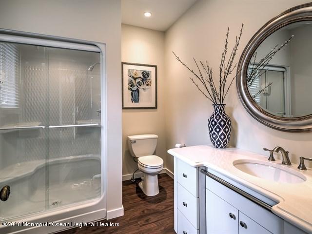 19 Russell Road Freehold, NJ 07728 - Photo 22 of 68 a bathroom with a sink a toilet and a mirror