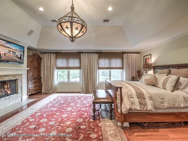 19 Russell Road Freehold, NJ 07728 - Photo 26 of 68 a bed room with a bed and a fireplace