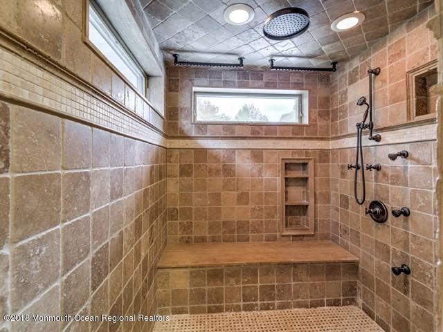 19 Russell Road Freehold, NJ 07728 - Photo 28 of 68 a bathroom with a mirror and a shower