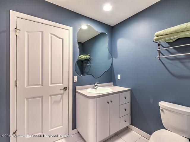 19 Russell Road Freehold, NJ 07728 - Photo 31 of 68 a bathroom with a toilet sink and mirror