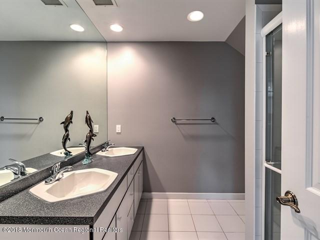 19 Russell Road Freehold, NJ 07728 - Photo 35 of 68 a bathroom with a sink double vanity and a mirror