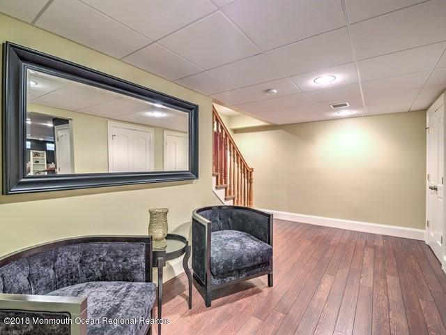 19 Russell Road Freehold, NJ 07728 - Photo 42 of 68 a living room with furniture and a wooden floor