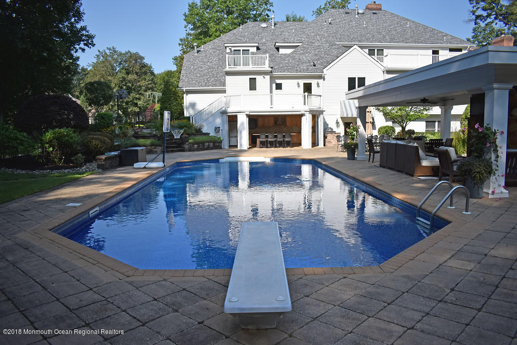 19 Russell Road Freehold, NJ 07728 - Photo 51 of 68 a view of a patio with couches table and chairs with wooden floor and fence