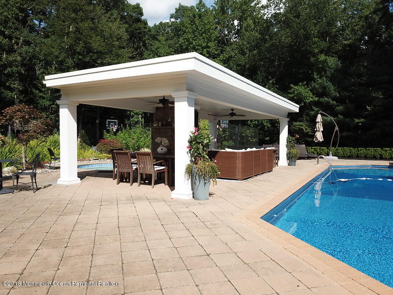 19 Russell Road Freehold, NJ 07728 - Photo 52 of 68 a view of a patio with table and chairs potted plants with wooden floor and fence