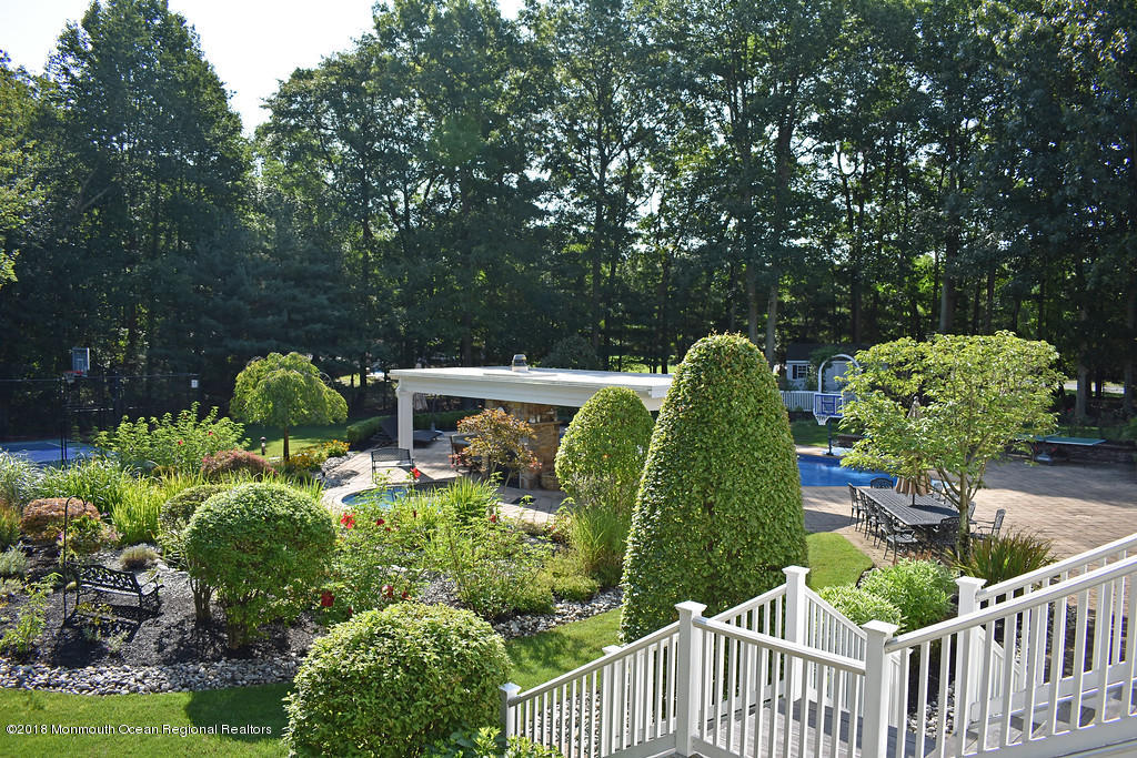 19 Russell Road Freehold, NJ 07728 - Photo 63 of 68 a view of a garden filled with plants and large trees