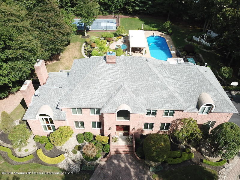 19 Russell Road Freehold, NJ 07728 - Photo 68 of 68 an aerial view of a house with swimming pool and large trees