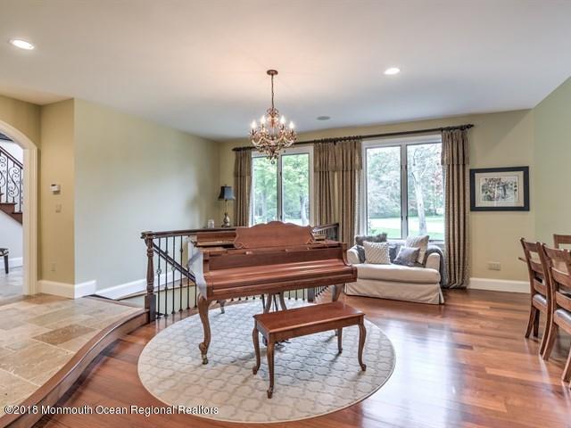 19 Russell Road Freehold, NJ 07728 - Photo 8 of 68 a living room with furniture and a chandelier