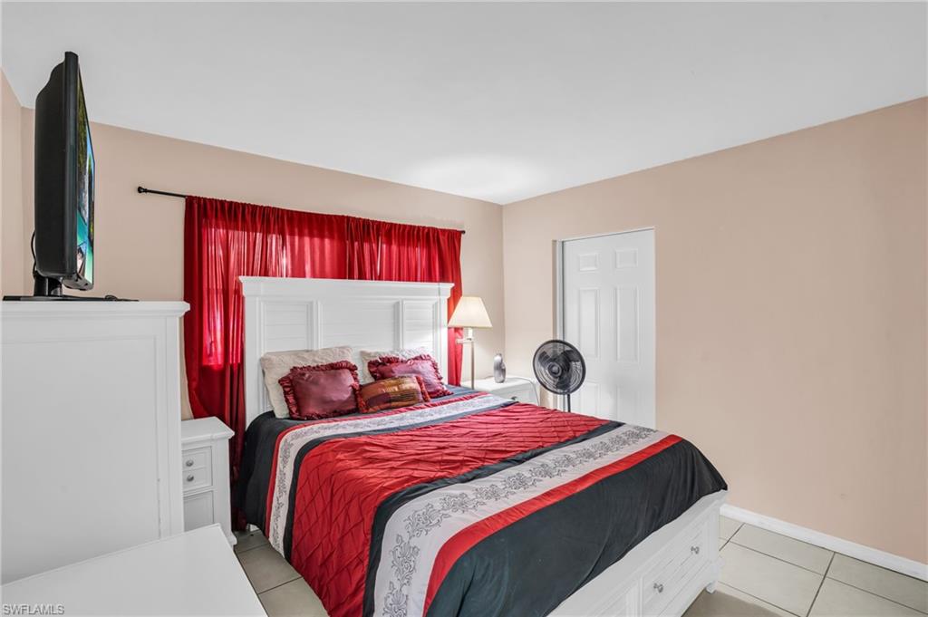 4333 20th Place Southwest Naples, FL 34116 - Photo 11 of 31 a bedroom with a bed and a large mirror