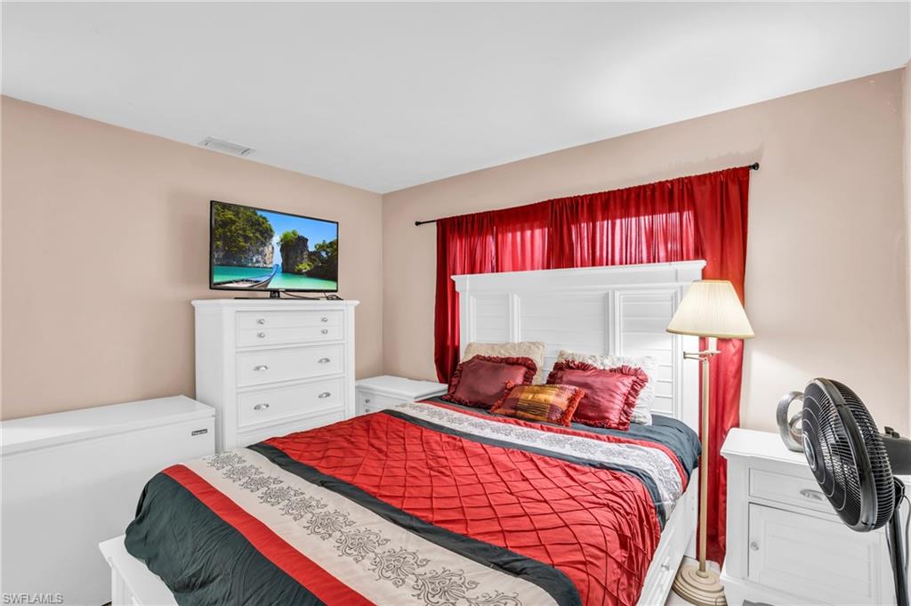 4333 20th Place Southwest Naples, FL 34116 - Photo 12 of 31 a bed room with a bed and a television
