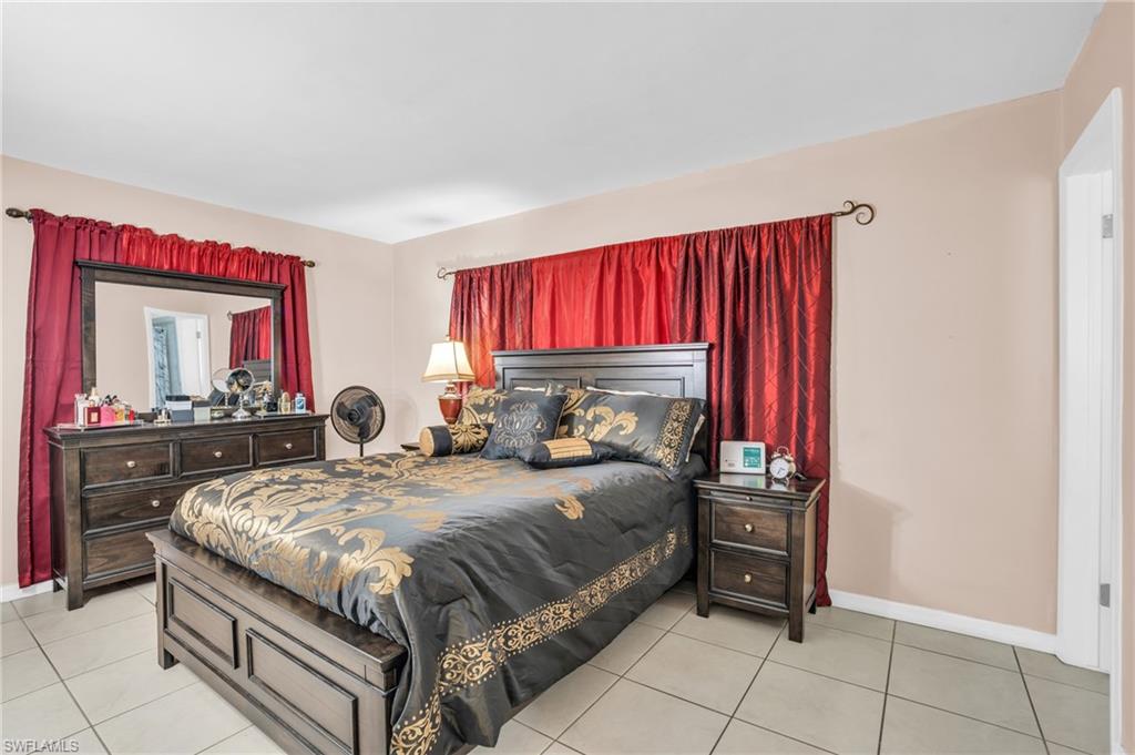 4333 20th Place Southwest Naples, FL 34116 - Photo 13 of 31 a bedroom with a bed and a dresser
