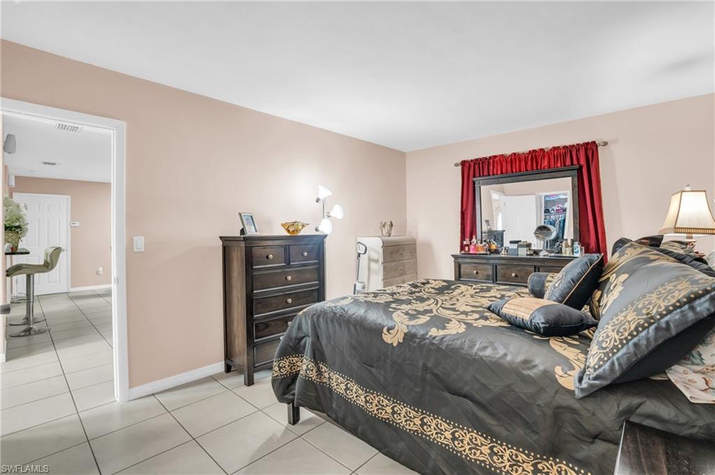 4333 20th Place Southwest Naples, FL 34116 - Photo 15 of 31 a bedroom with a bed and a dresser