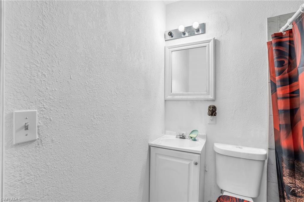 4333 20th Place Southwest Naples, FL 34116 - Photo 20 of 31 a bathroom with a sink a toilet and vanity
