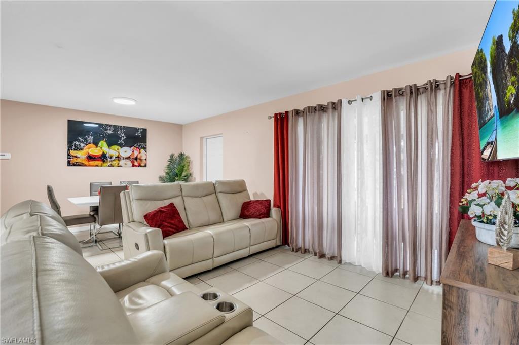 4333 20th Place Southwest Naples, FL 34116 - Photo 2 of 31 a living room with furniture and a curtain