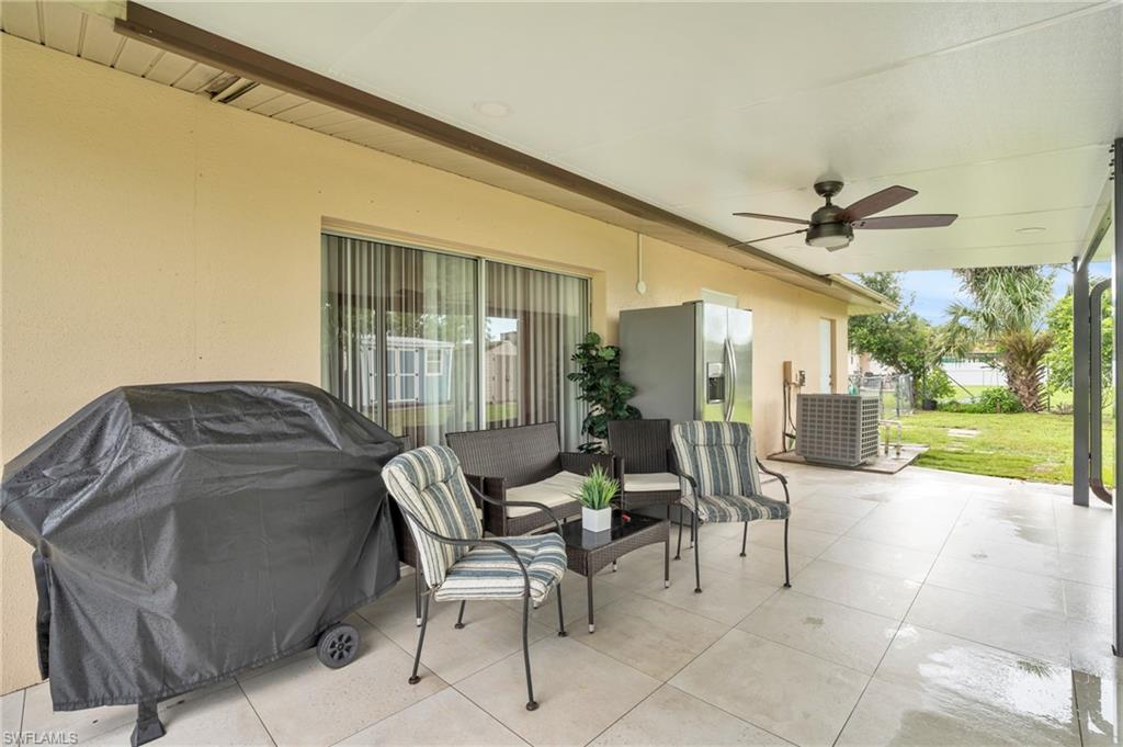 4333 20th Place Southwest Naples, FL 34116 - Photo 22 of 31 a view of a patio with a table and chairs under an umbrella