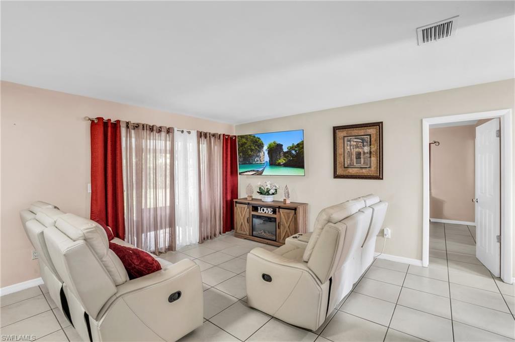 4333 20th Place Southwest Naples, FL 34116 - Photo 5 of 31 a living room with furniture and a flat screen tv