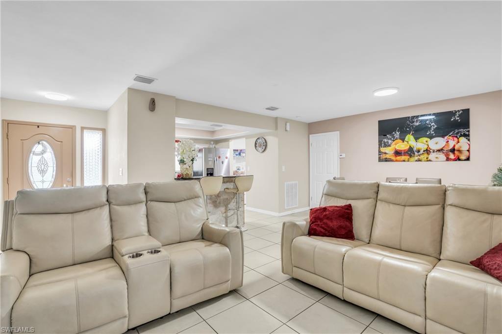 4333 20th Place Southwest Naples, FL 34116 - Photo 6 of 31 a living room with furniture and a large window