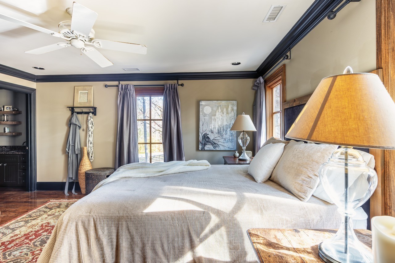 5551 Parker Branch Road Franklin, TN 37064 - Photo 45 of 67 a bedroom with a large bed and a chandelier