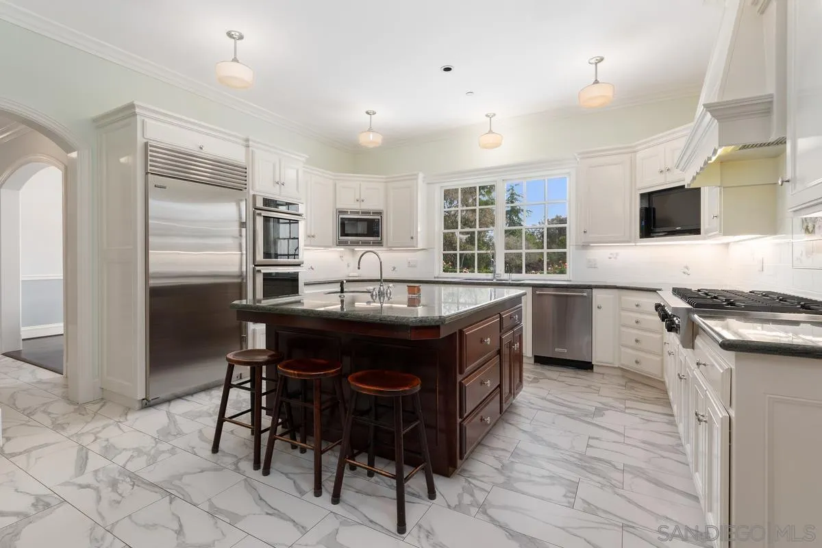 17032 Circa Oriente Rancho Santa Fe, CA 92067 - Photo 17 of 75 a kitchen with a sink refrigerator and cabinets
