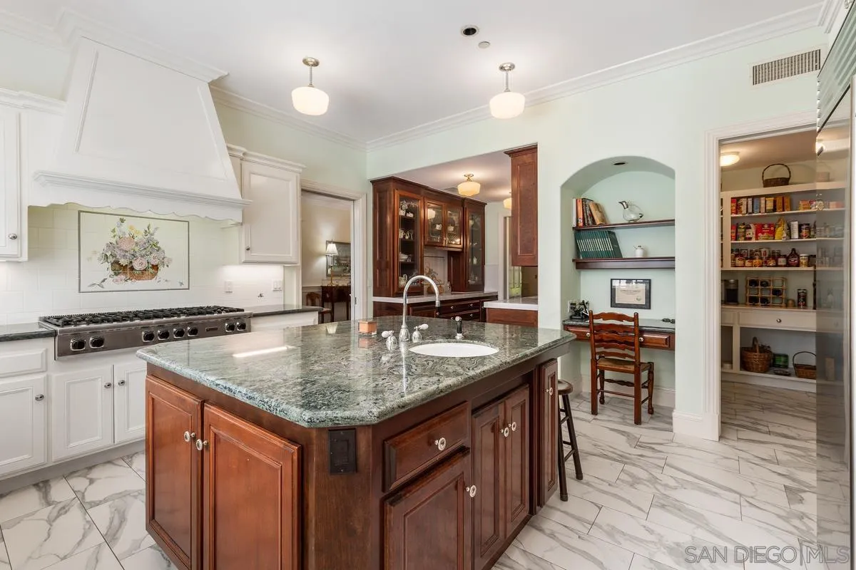 17032 Circa Oriente Rancho Santa Fe, CA 92067 - Photo 20 of 75 a kitchen with stainless steel appliances granite countertop a sink and a stove