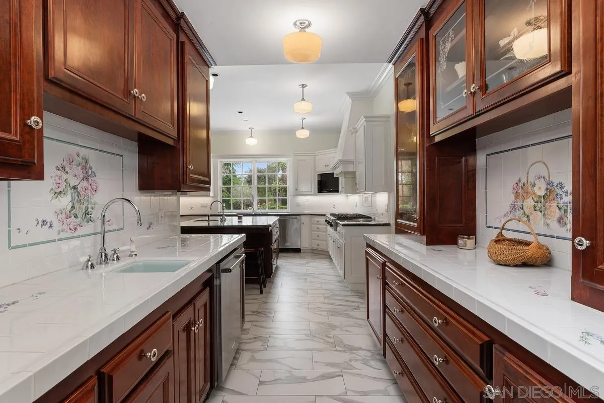 17032 Circa Oriente Rancho Santa Fe, CA 92067 - Photo 21 of 75 a kitchen with stainless steel appliances a sink stove and cabinets