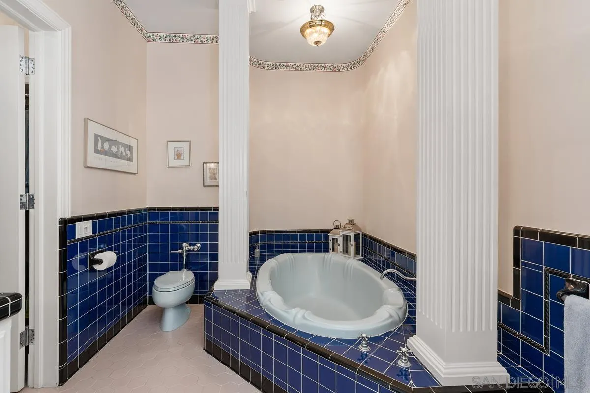 17032 Circa Oriente Rancho Santa Fe, CA 92067 - Photo 32 of 75 a bathroom with a granite countertop toilet a sink and a mirror