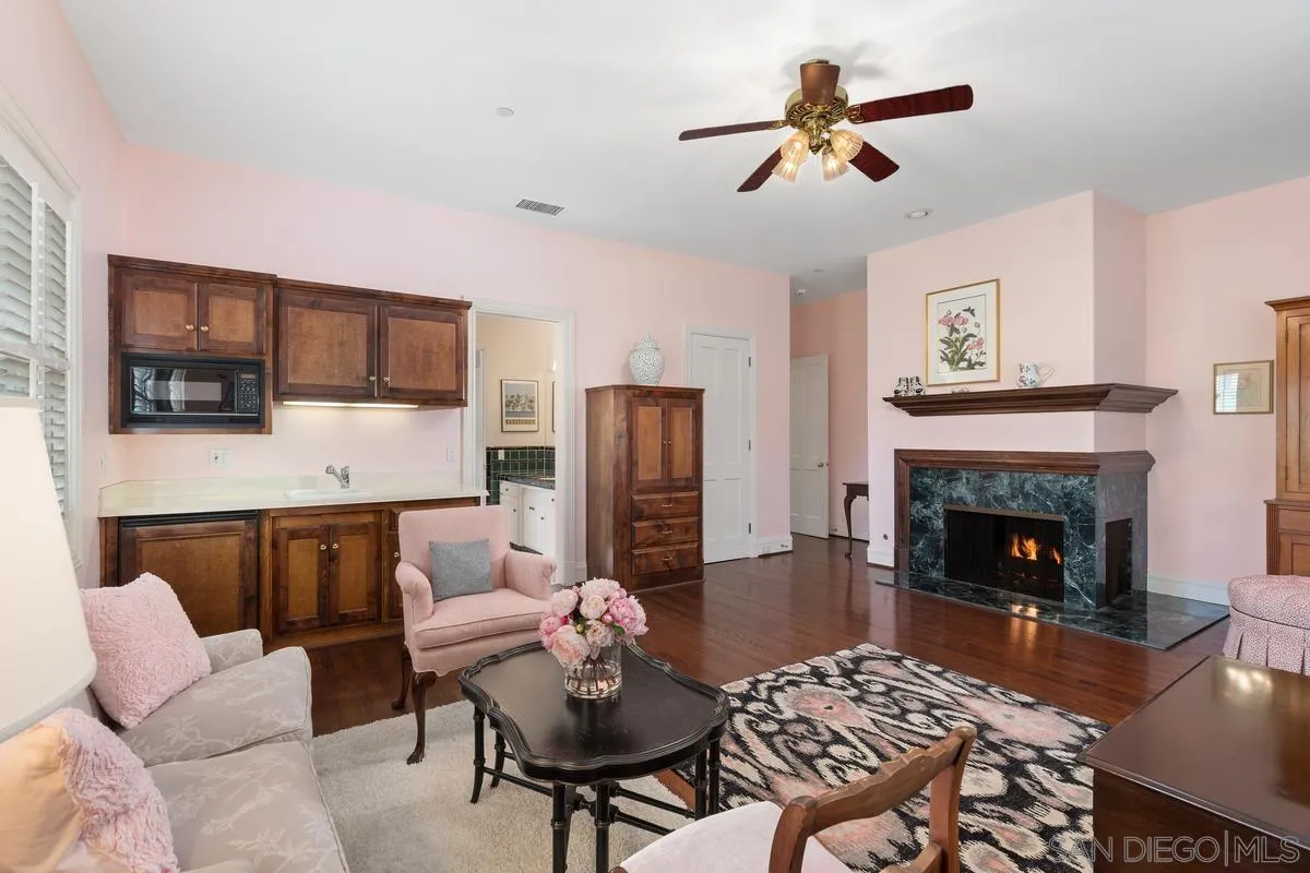 17032 Circa Oriente Rancho Santa Fe, CA 92067 - Photo 37 of 75 a living room with furniture a fireplace and a flat screen tv