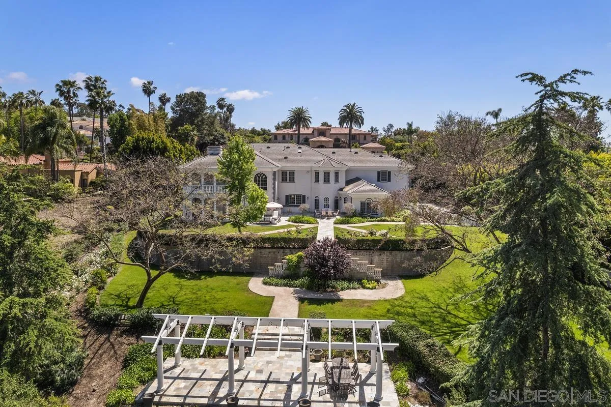 17032 Circa Oriente Rancho Santa Fe, CA 92067 - Photo 51 of 75 a aerial view of a house with swimming pool and large trees