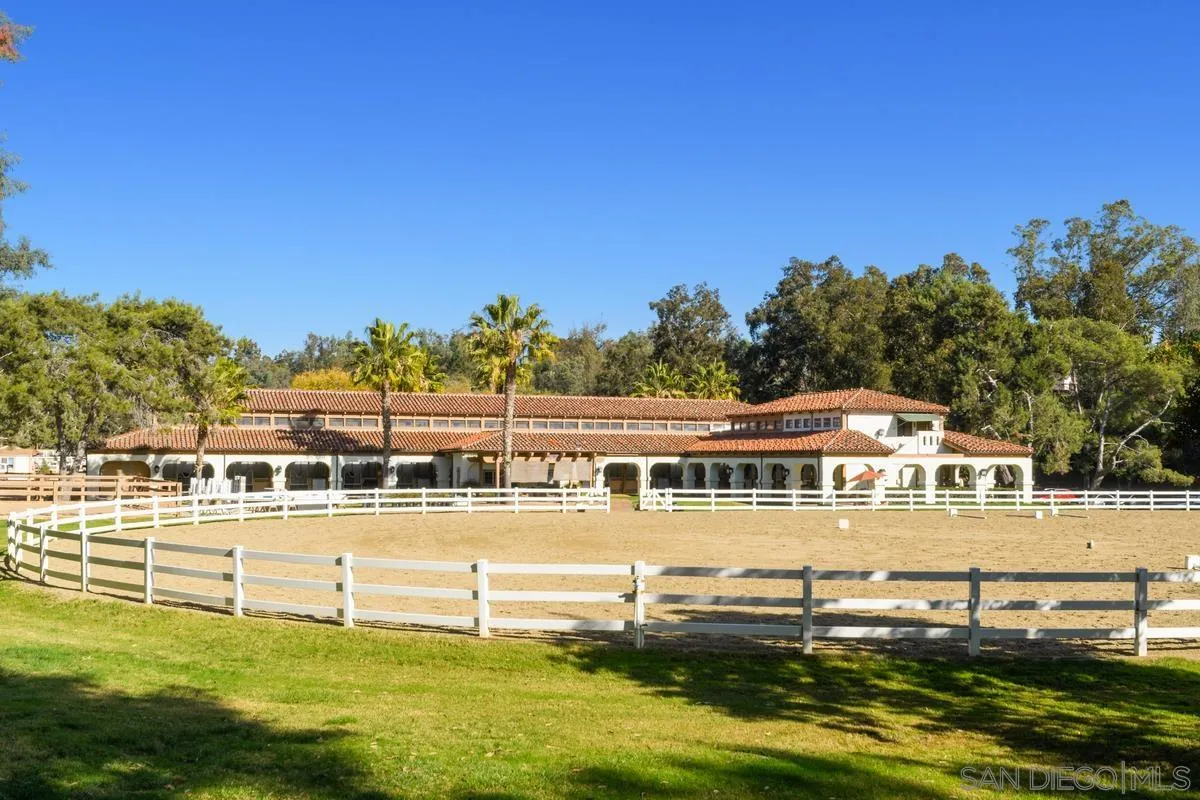 17032 Circa Oriente Rancho Santa Fe, CA 92067 - Photo 64 of 75 a view of a large pool with lawn chairs and a big yard