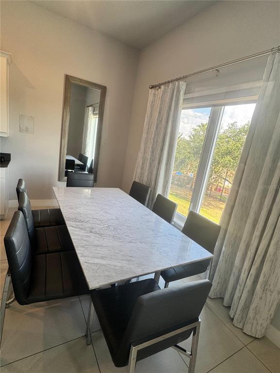7770 Sandy Ridge Drive, Unit 210 Reunion, FL 34747 - Photo 16 of 42 a dining room with a table and chairs in it