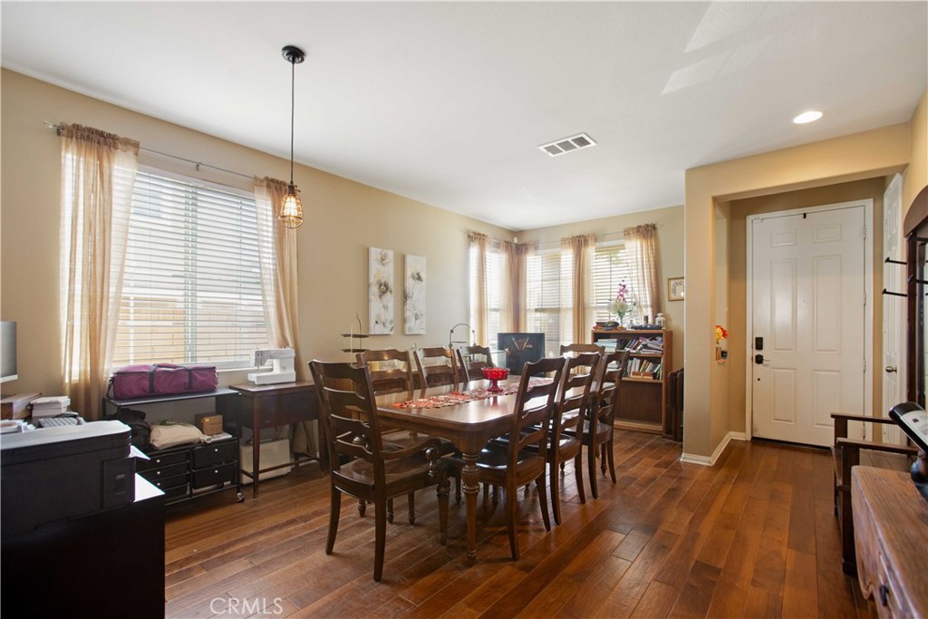 3866 Obsidian Road San Bernardino, CA 92407 - Photo 13 of 64 a view of a a dining room with furniture window and wooden floor