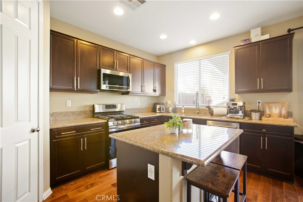 3866 Obsidian Road San Bernardino, CA 92407 - Photo 16 of 64 a kitchen with a sink stove top oven and microwave