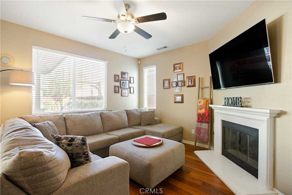3866 Obsidian Road San Bernardino, CA 92407 - Photo 20 of 64 a living room with furniture a flat screen tv and a fireplace