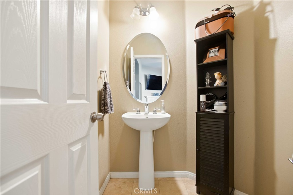 3866 Obsidian Road San Bernardino, CA 92407 - Photo 22 of 64 a bathroom with a sink and a mirror