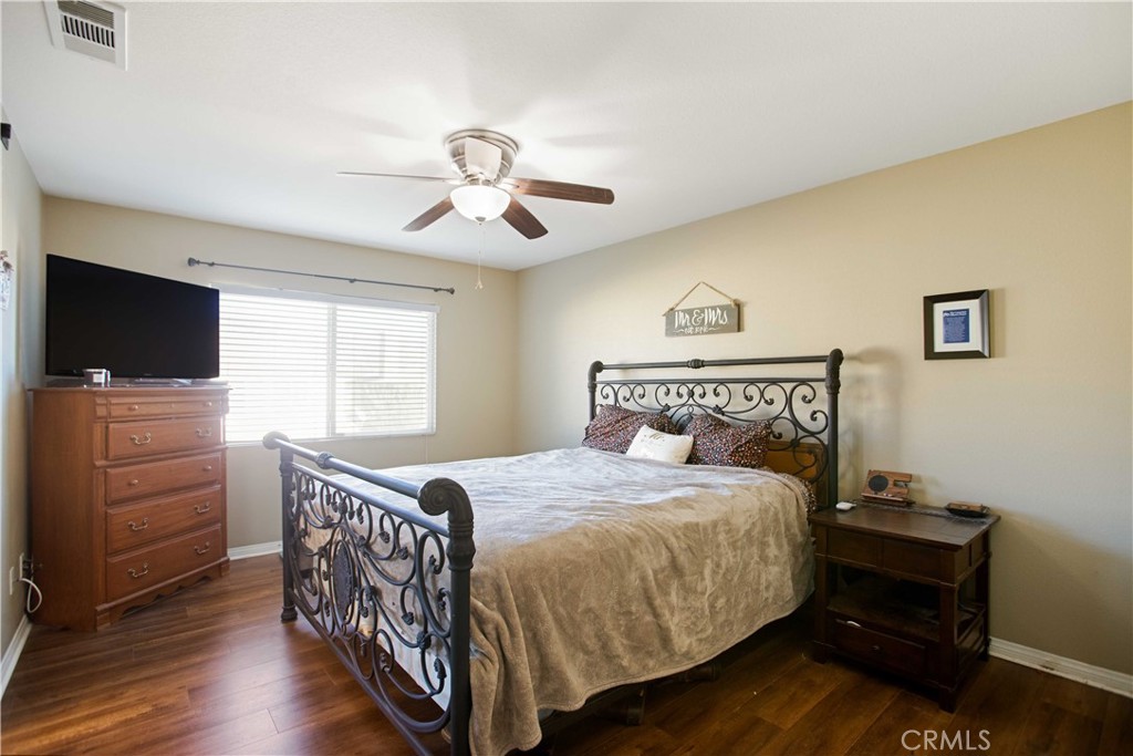 3866 Obsidian Road San Bernardino, CA 92407 - Photo 24 of 64 a bedroom with a bed and a flat screen tv