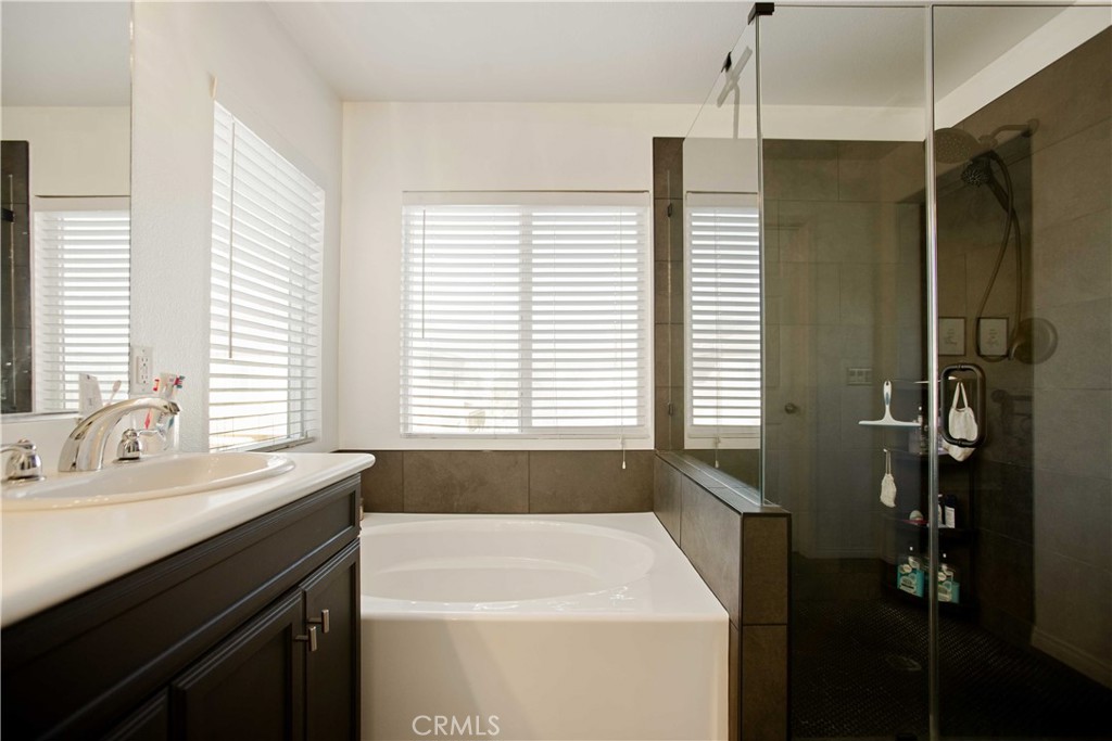 3866 Obsidian Road San Bernardino, CA 92407 - Photo 28 of 64 a bathroom with a sink a bathtub and a shower