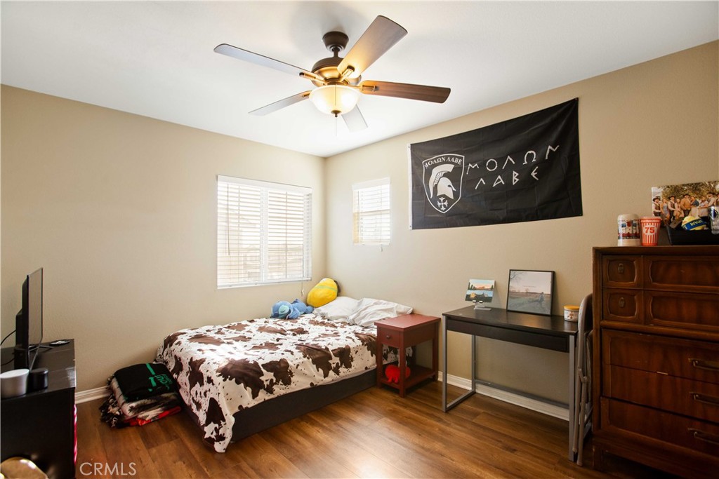 3866 Obsidian Road San Bernardino, CA 92407 - Photo 31 of 64 a bedroom with a bed and a chandelier