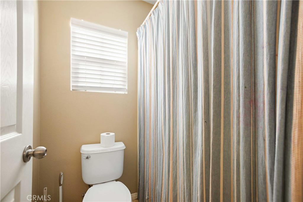 3866 Obsidian Road San Bernardino, CA 92407 - Photo 35 of 64 a white toilet sitting next to a window