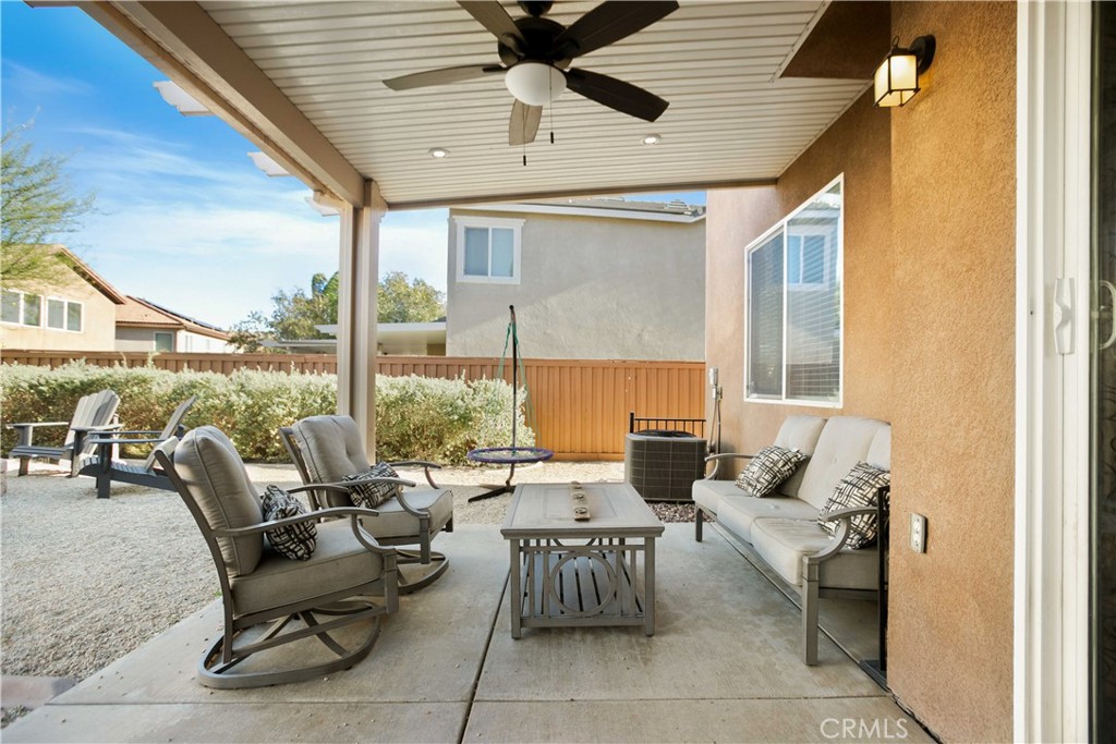 3866 Obsidian Road San Bernardino, CA 92407 - Photo 38 of 64 a living room with furniture and floor to ceiling windows