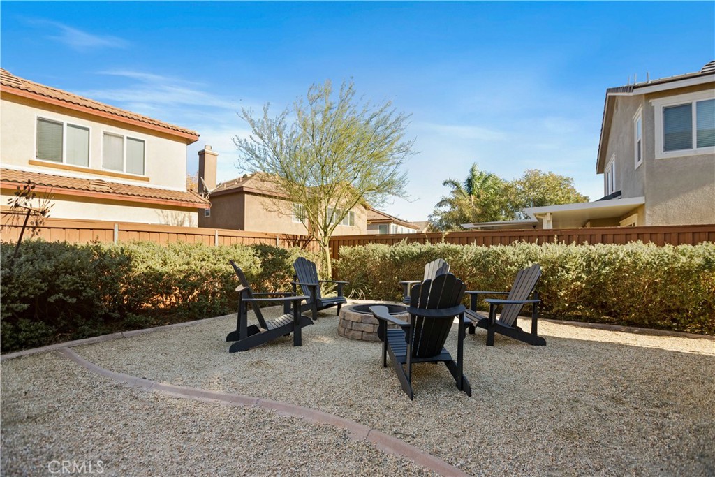 3866 Obsidian Road San Bernardino, CA 92407 - Photo 40 of 64 a view of a patio with table and chairs and potted plants by side of it