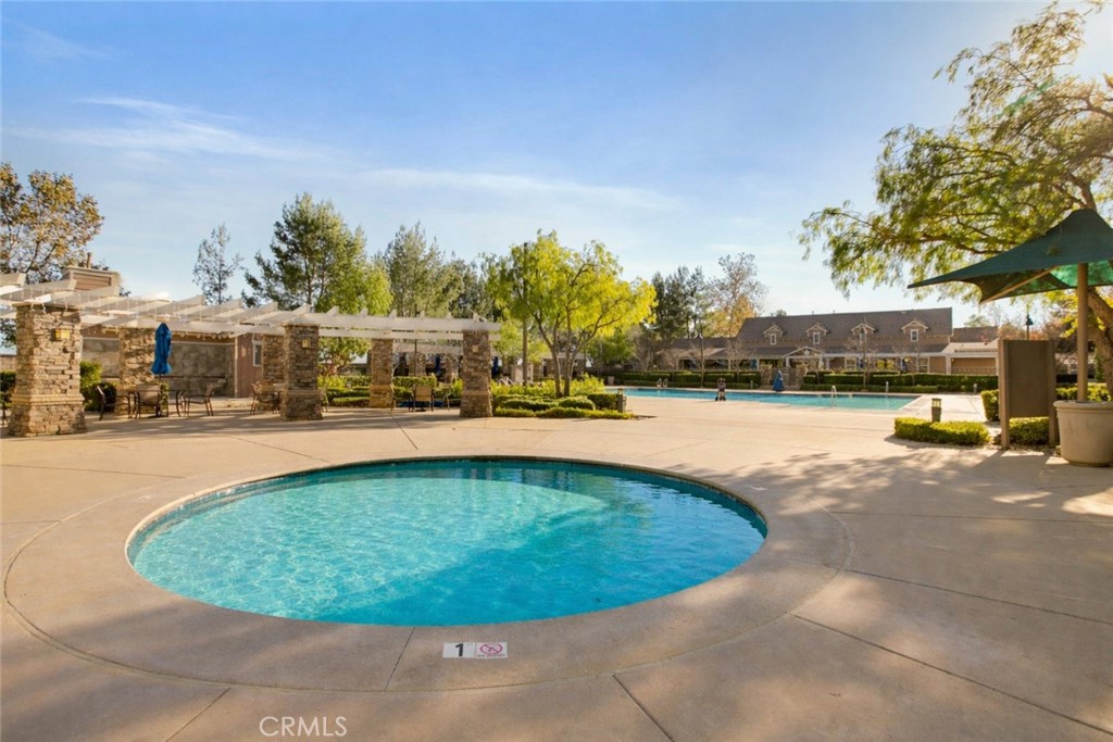 3866 Obsidian Road San Bernardino, CA 92407 - Photo 49 of 64 a view of swimming pool with outdoor seating and trees in the background