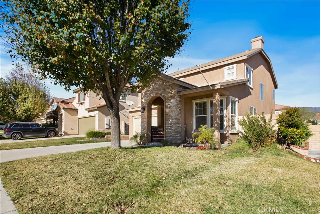 3866 Obsidian Road San Bernardino, CA 92407 - Photo 8 of 64 a front view of a house with garden