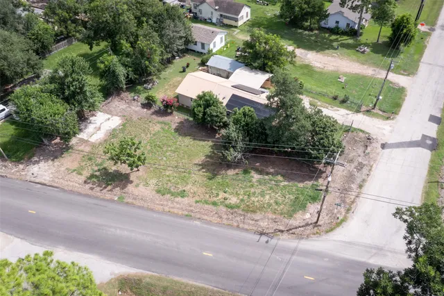 an aerial view of a house with a yard basket ball court and outdoor seating