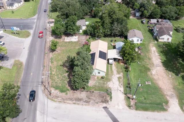 an aerial view of houses with yard