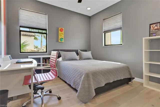 a bedroom with a bed and a desk