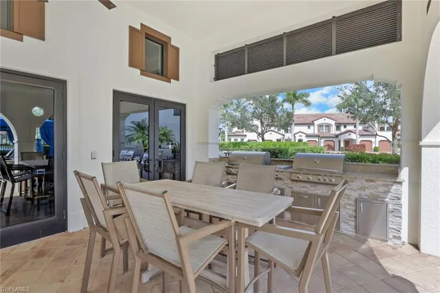a view of an outdoor dining space with a table and chairs