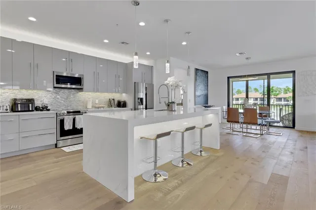 a kitchen with counter top space cabinets and appliances