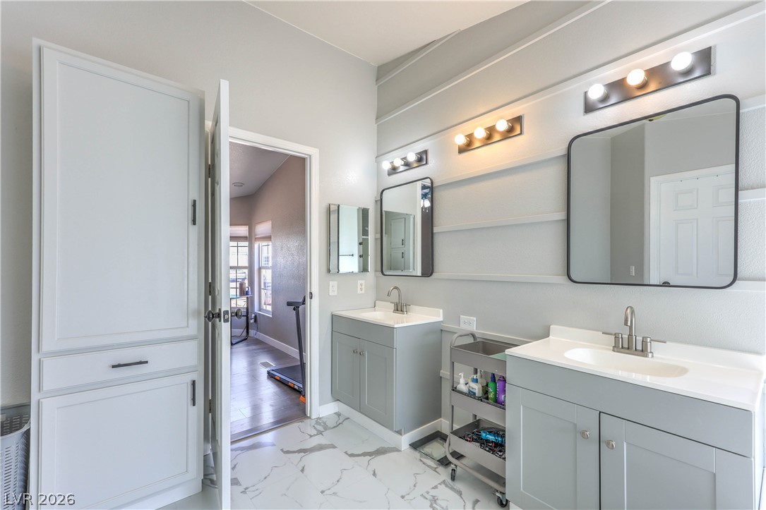 348 Tres Palomas Street Overton, NV 89040 - Photo 20 of 41 A well-appointed primary bathroom showcases dual vanities, modern fixtures, and ample storage.