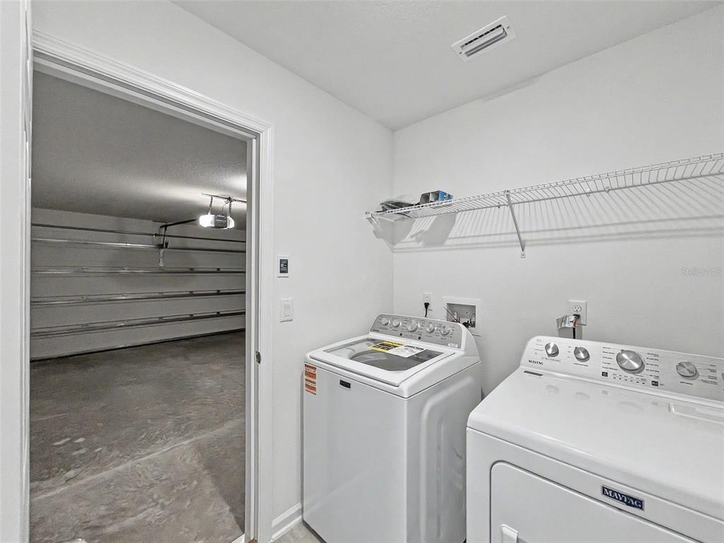 55 Signet Circle Flagler Beach, FL 32136 - Photo 16 of 39 a view of storage and utility room with washer and dryer