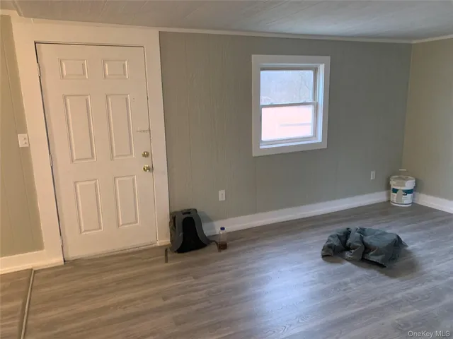 a room with hard wood floors and a window